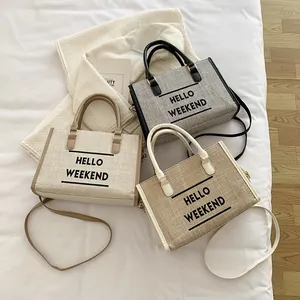 Three minimalist canvas tote bags with Hello Weekend print in a cozy lifestyle setting