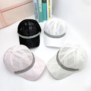 Detailed view of four lace mesh sun hats with sparkling rhinestone bands and elegant floral pattern