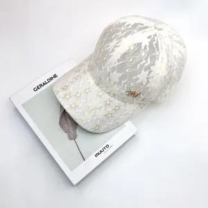 Elegant beige floral lace baseball cap with a gold M letter charm and breathable texture