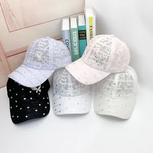 Detail showing lace fabric textures and rhinestone bows on five colorful baseball caps