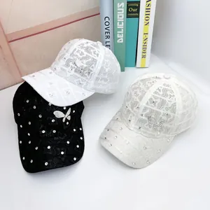 Lace baseball caps with glittery rhinestones and butterfly ornaments in black, white, and beige