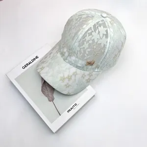 Lace baseball cap in mint green with metal M logo and floral embroidery patterns