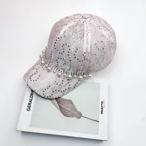 Detail of pink lace baseball cap with sparkling sequins, pearls and rhinestone fringe