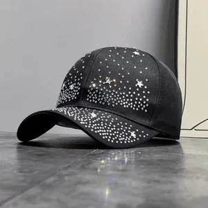 Close-up of sparkling silver rhinestones forming star patterns on a black baseball cap