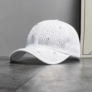 Close-up of sparkling silver rhinestones and star crystals on white cotton baseball cap