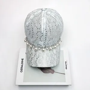 Detailed shot of sparkling silver sequins and lace on a stylish rhinestone baseball cap