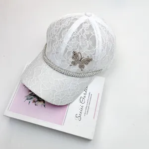 Elegant white lace baseball cap featuring rhinestone butterfly and pearl trim detailing