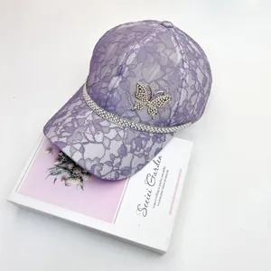 Close-up of lilac lace baseball cap featuring rhinestones and a crystal butterfly
