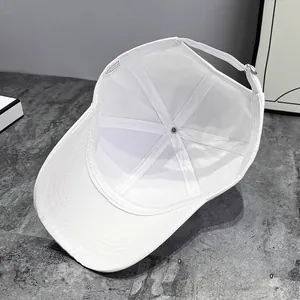 Detail of white baseball cap interior showing polyester sweatband and metal buckle