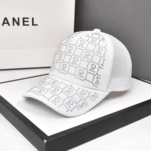 Close-up of luxury white mesh baseball cap featuring silver rhinestone letter patterns