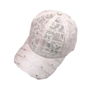 Pale pink lace baseball cap featuring sparkling rhinestones and a silver butterfly motif
