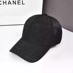 Close-up of a black baseball cap featuring rhinestone lettering and breathable mesh back