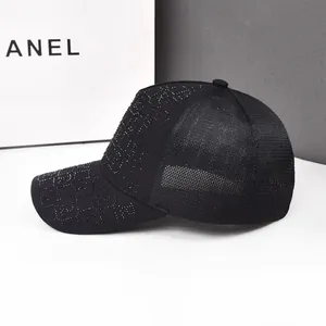 Detail of black baseball cap featuring shimmering rhinestone patterns and mesh back design