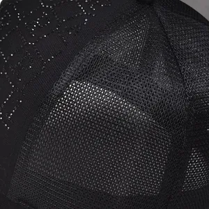 Detailed close-up of rhinestone letter patterns on a black mesh breathable baseball cap