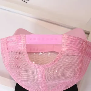 Detail of pink mesh trucker hat showing breathable fabric and adjustable snapback closure