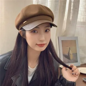 Brown wool newsboy cap with PU leather brim and gold metal detail shown in profile