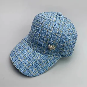 Blue tweed baseball cap with gold thread and sparkling heart emblem for stylish women