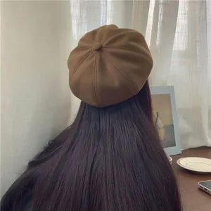 Rear view of a dark brown wool newsboy cap on model showing the paneled crown design