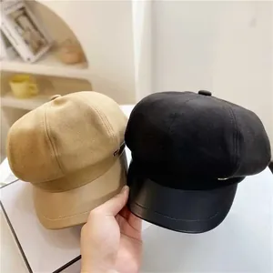 Detail showing wool blend octagonal caps in khaki and black with PU leather brims