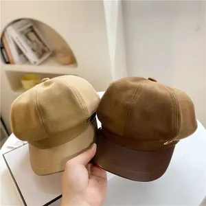 Detail of wool octagonal hats with PU leather brims in beige and brown colors
