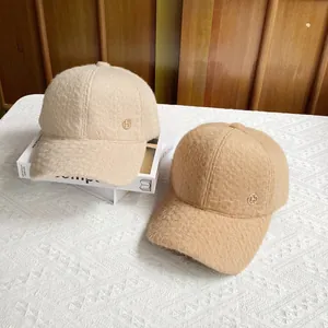 Winter plush baseball cap with H-logo in cream and light brown faux sheepskin wool