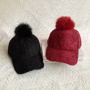 Faux fur pompom detail on thick sherpa fleece baseball caps in burgundy and black