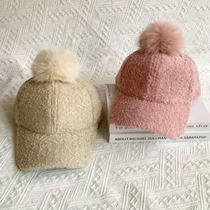 Plush lamb wool baseball hats with faux fox fur pom poms in beige and pink for winter