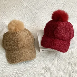 Lamb wool baseball caps with faux fox fur pom poms in khaki and burgundy colors