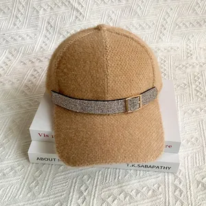 Detailed macro view of camel knitted baseball cap with rhinestone band and golden buckle