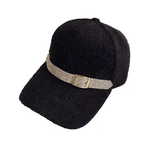 Chic black fleece baseball cap featuring a sparkling rhinestone belt and gold metal buckle