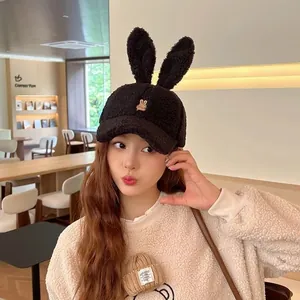 Close-up of black fuzzy bunny ear baseball cap with rabbit embroidery and plush texture