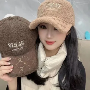 Detailed close-up of embroidered PARIS text on faux shearling patchwork baseball cap