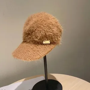 Close-up of caramel mohair empty top baseball cap with detailed golden metal logo plate