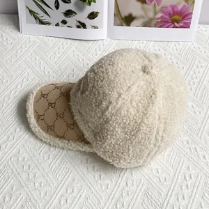 Detailed close-up of beige lamb wool baseball cap with stylish golden rivet logo on the brim