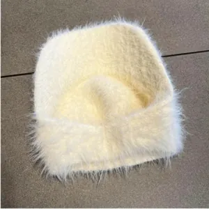 Close-up of beige mohair open top sun hat with soft faux fur texture for winter