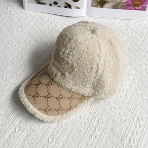 Detail of beige fleece baseball cap featuring 3D PARIS embroidery and studded R patterns