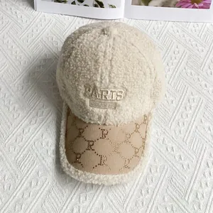 Detail of beige fleece baseball cap with Paris embroidery and patterned leather brim