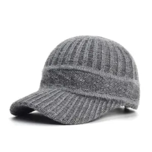 Close-up of gray knitted baseball cap showing ribbed texture and cable knit details