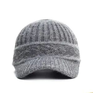 Close-up detail of grey knitted baseball cap showing ribbed texture and fuzzy warm material