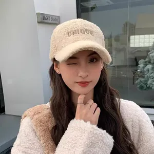 Close-up of beige Sherpa baseball cap featuring UNIQUE embroidery for winter warmth