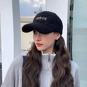 Detail of UNIQUE gold embroidery on black faux shearling warm winter baseball cap
