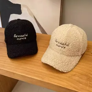 Winter lamb wool baseball caps with embroidered lettering in black and beige tones