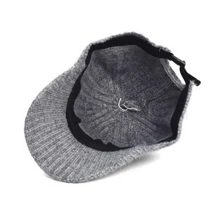 Detail view of the gray knitted baseball cap interior with adjustable plastic buckle strap