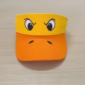 Detail of vibrant yellow and orange sun visor hat with cartoon eye embroidery details