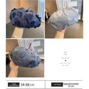 Detail of denim beret featuring heart embroidery and 54-58cm head circumference size guide