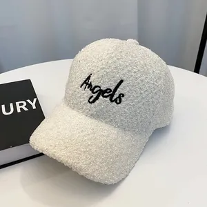 Detail of white teddy fleece baseball cap featuring black embroidered Angels lettering