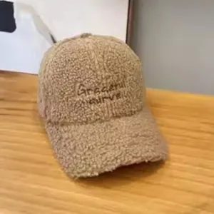 Detailed view of Graceful curve embroidery on warm brown sherpa baseball cap texture