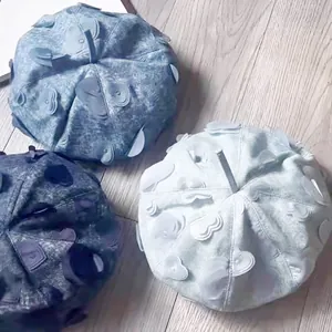Three denim beret hats with 3D heart embroidery patches in dark, medium, and light blue