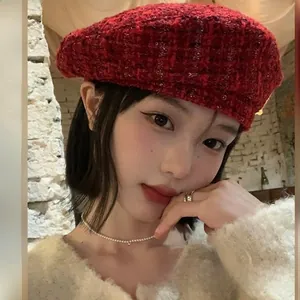 Detail of dark red tweed beret with elegant woven texture and vintage pattern