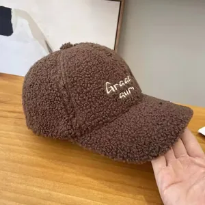 Close-up of the plush dark brown sherpa baseball cap with Gracious letter embroidery